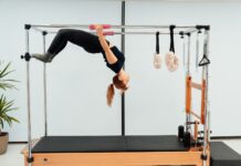필라테스, 건강한 몸과 마음을 위한 최고의 선택 a woman doing a handstand on a pivot machine