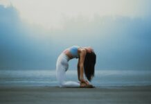 필라테스, 건강과 아름다움을 동시에 잡는 운동법 A woman doing a yoga pose on the beach