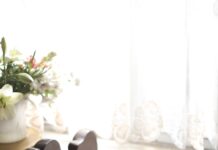 “슬기로운 수면 습관, 한국인의 건강 지키는 첫걸음” woman sleeping on bed beside book